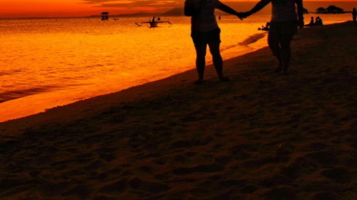 holding hands at the beach