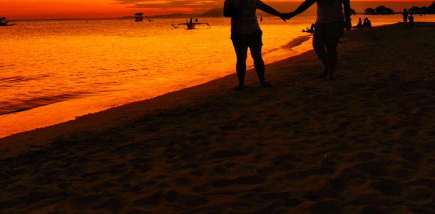 holding hands at the beach