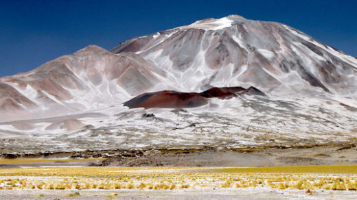 A vast volcano rises to the heavens, commanding the view.