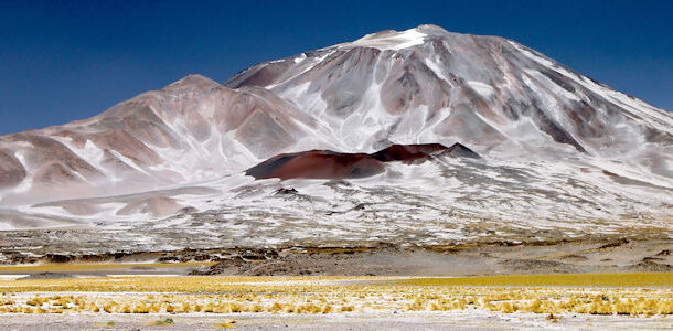 A vast volcano rises to the heavens, commanding the view.